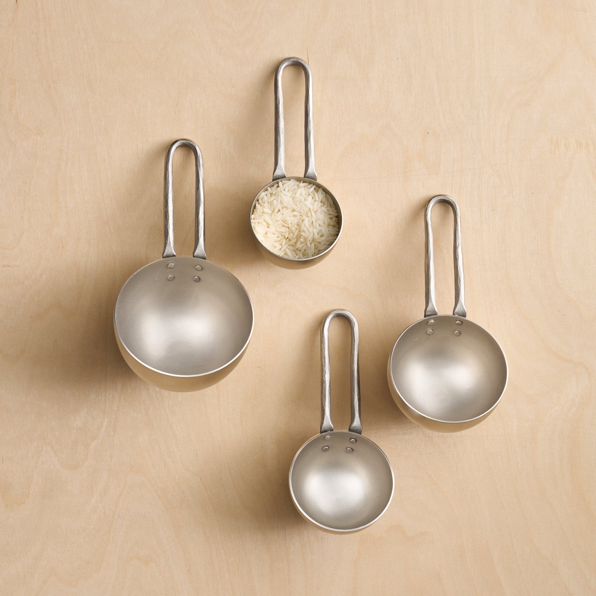 Four pewter metal measuring scoops - cooking utensil collection at Better World Bio