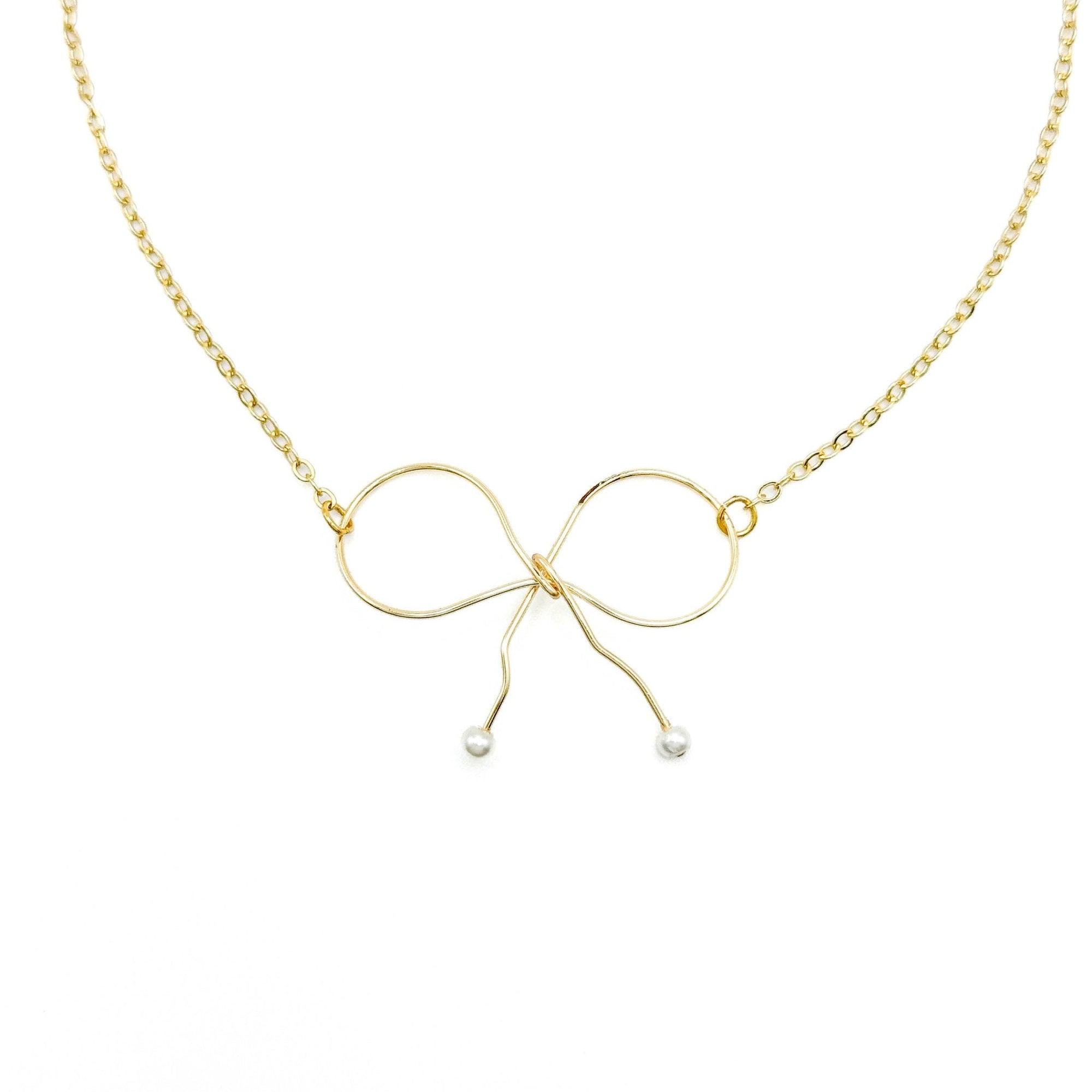 Gold colored necklace with a bow design - necklace collection at Better World Bio