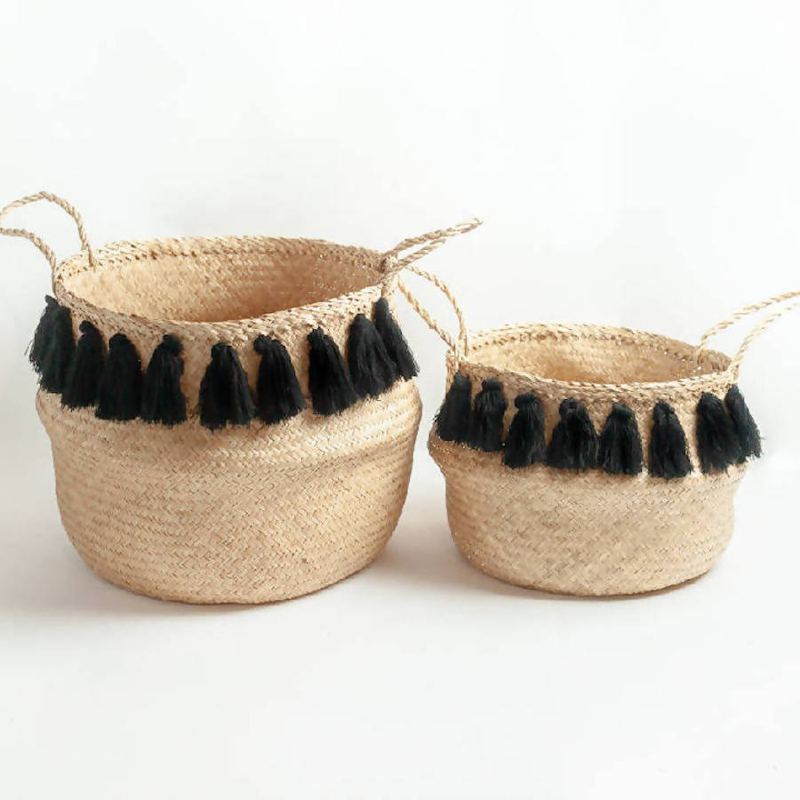 Black and brown tasseled belly basket made of seagrass, blending natural texture with bold design for stylish home storage.