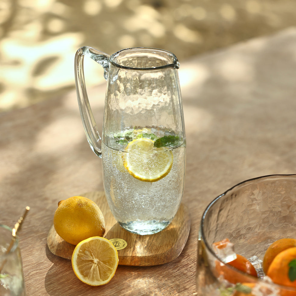 Glass pitcher with water and a lemon inside - pitchers and carafes collection at Better World Bio