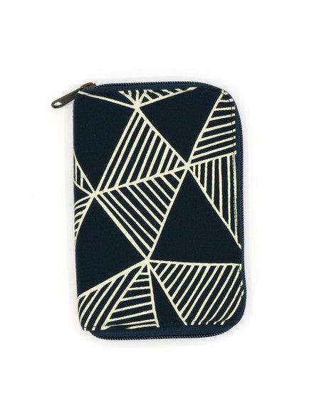 A closed navy blue zippered jewelry travel organizer with a geometric pattern, featuring compartments for organizing jewelry such as earrings, rings, and necklaces.