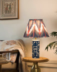 Decorative lamp with a colorful shade on a small table in a cozy living room.