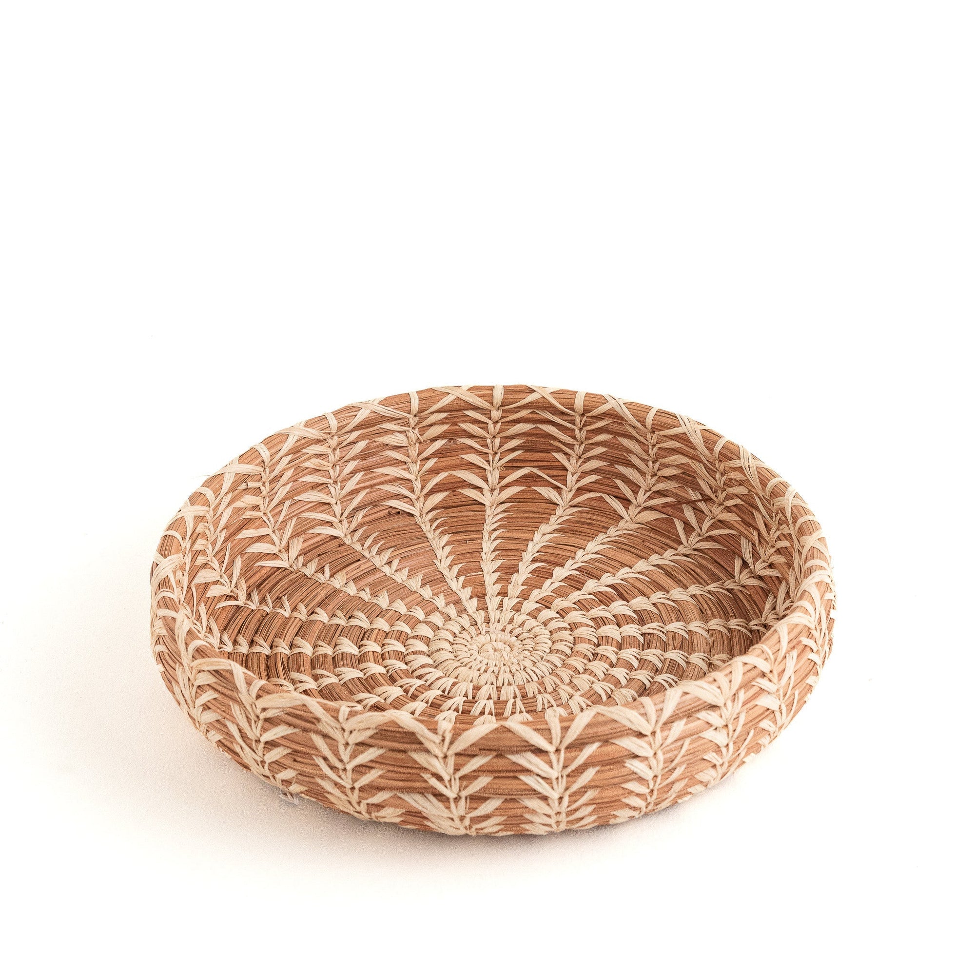Woven basket with a circular design on a white background