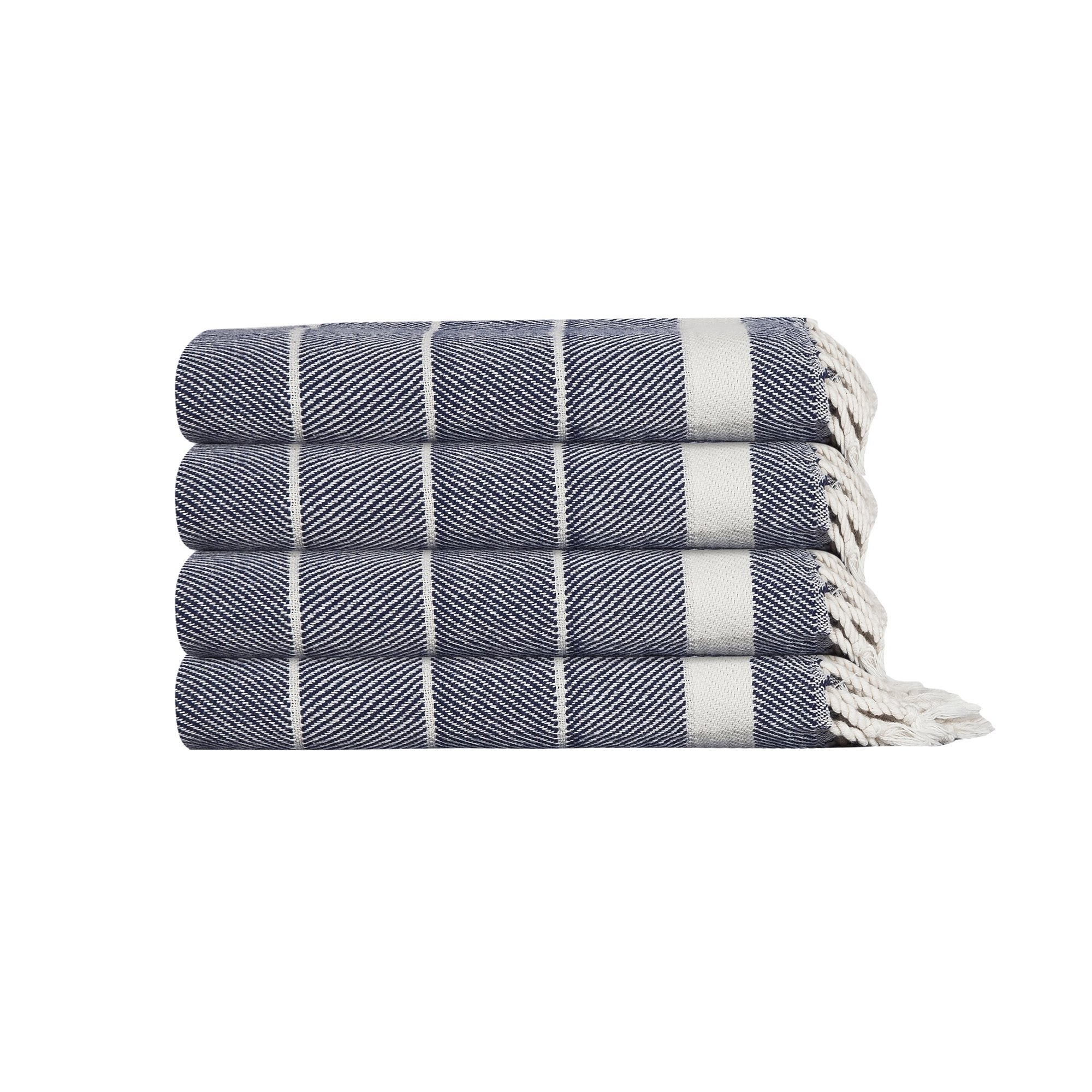 Stack of three folded blue and white patterned towels on a white background