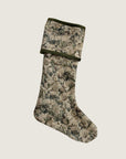 A reversible holiday stocking featuring a floral tapestry design in green, white, and light brown, with green velvet piping