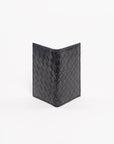 Black woven wallet on a white background