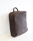 A leather book bag in brown, displayed upright against a white background.