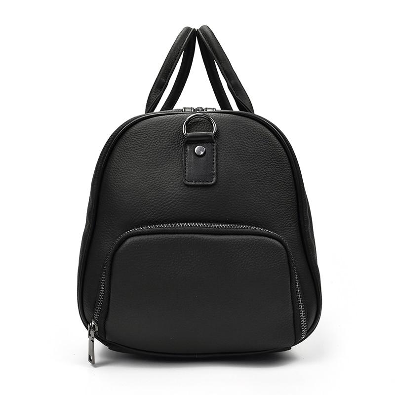 The side of a black leather weekender bag with a leather handle and visible stitching details.