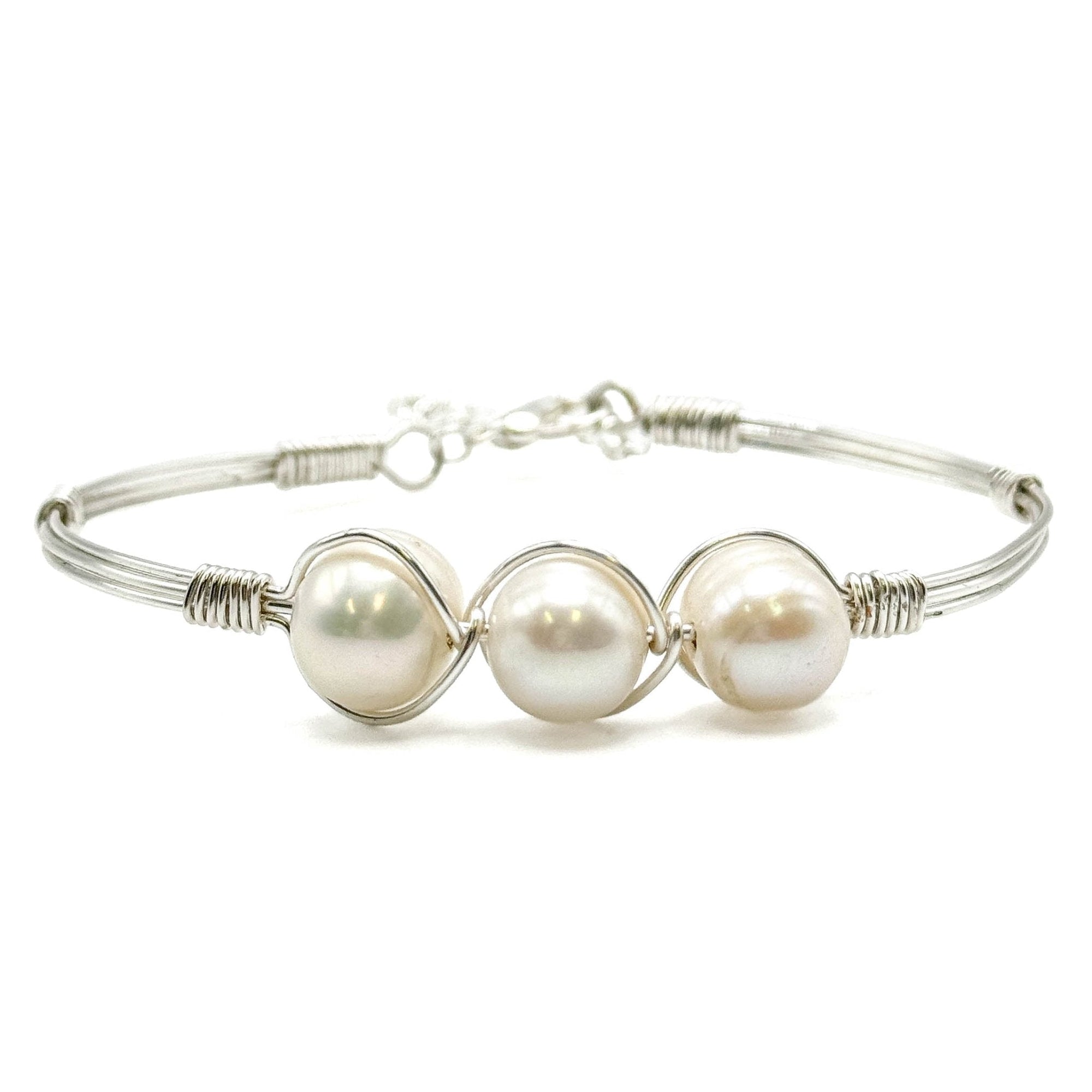 A silver-plated bracelet featuring three fresh water pearls and a safety lobster clasp.