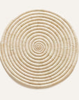 A circular natural raffia placemat with a spiral pattern, displayed on a white background