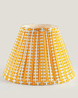 Yellow and white patterned lampshade on a light gray background
