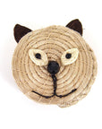 A handwoven beige basket with a face resembling a cat, including ears, eyes, and a nose, made from sisal