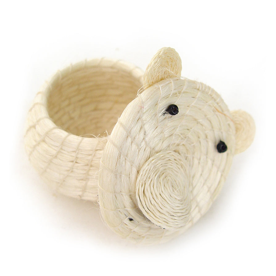 A white lidded basket hand woven out of sisal, designed to resemble a polar bear with the lid off