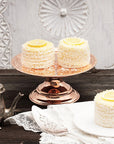 A vintage inspired copper cake stand holding a dessert