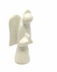 A hand-carved soapstone sculpture of an angel, with a predominantly gray and earthy tone, standing with wings extended
