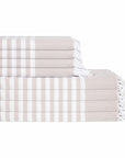 Stack of beige and white striped towels on a white background