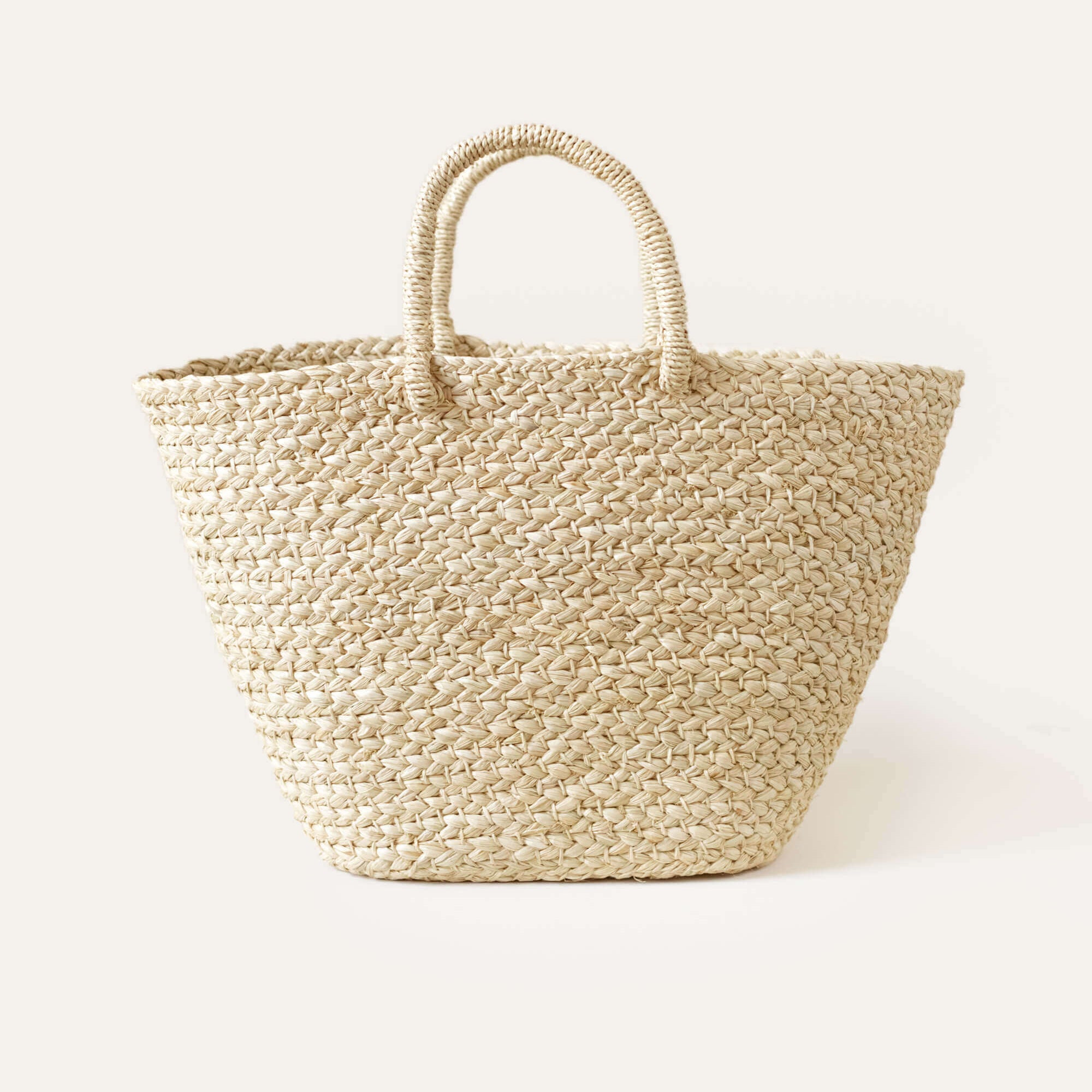 A natural-colored braided raffia day bag with sturdy handles.