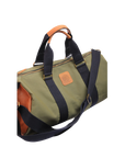 A green and brown duffel bag with black straps and a tan leather bottom, standing upright on a plain background.