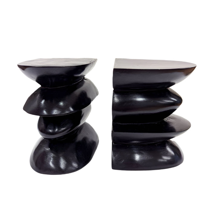 A pair of black carved stone bookends with a modern design.