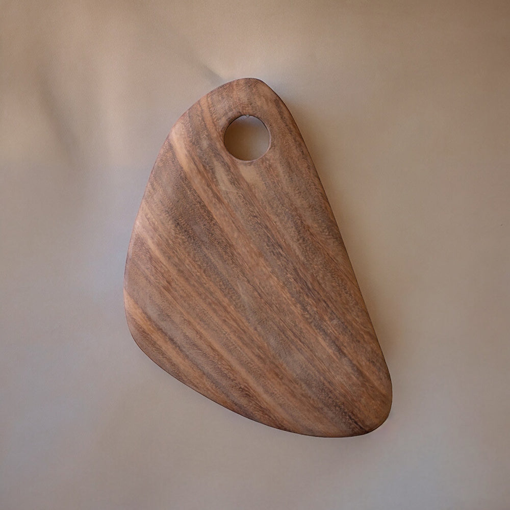 A hand-carved wooden cutting board with a smooth finish and a hole on one corner for hanging