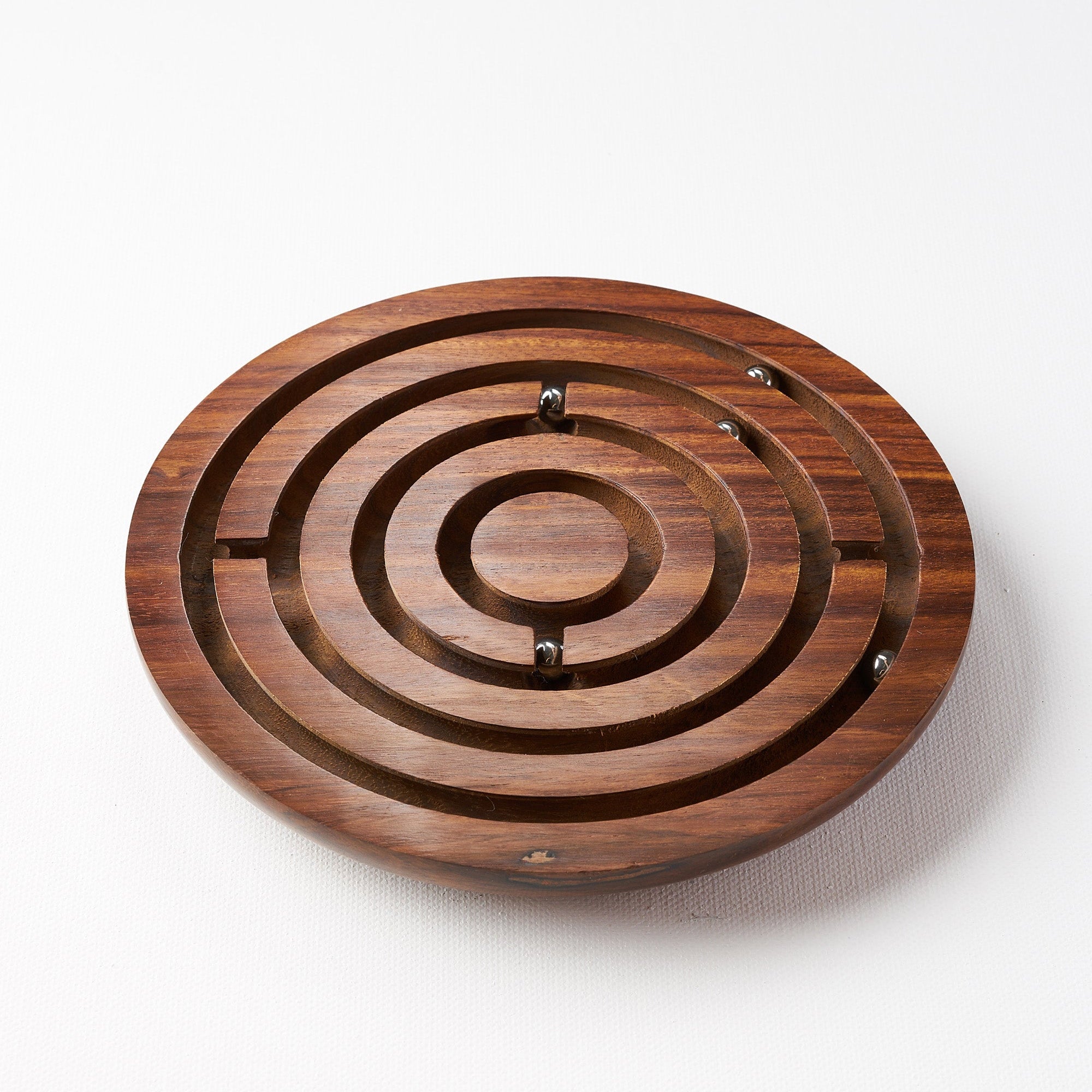 Wooden labyrinth puzzle on a white background