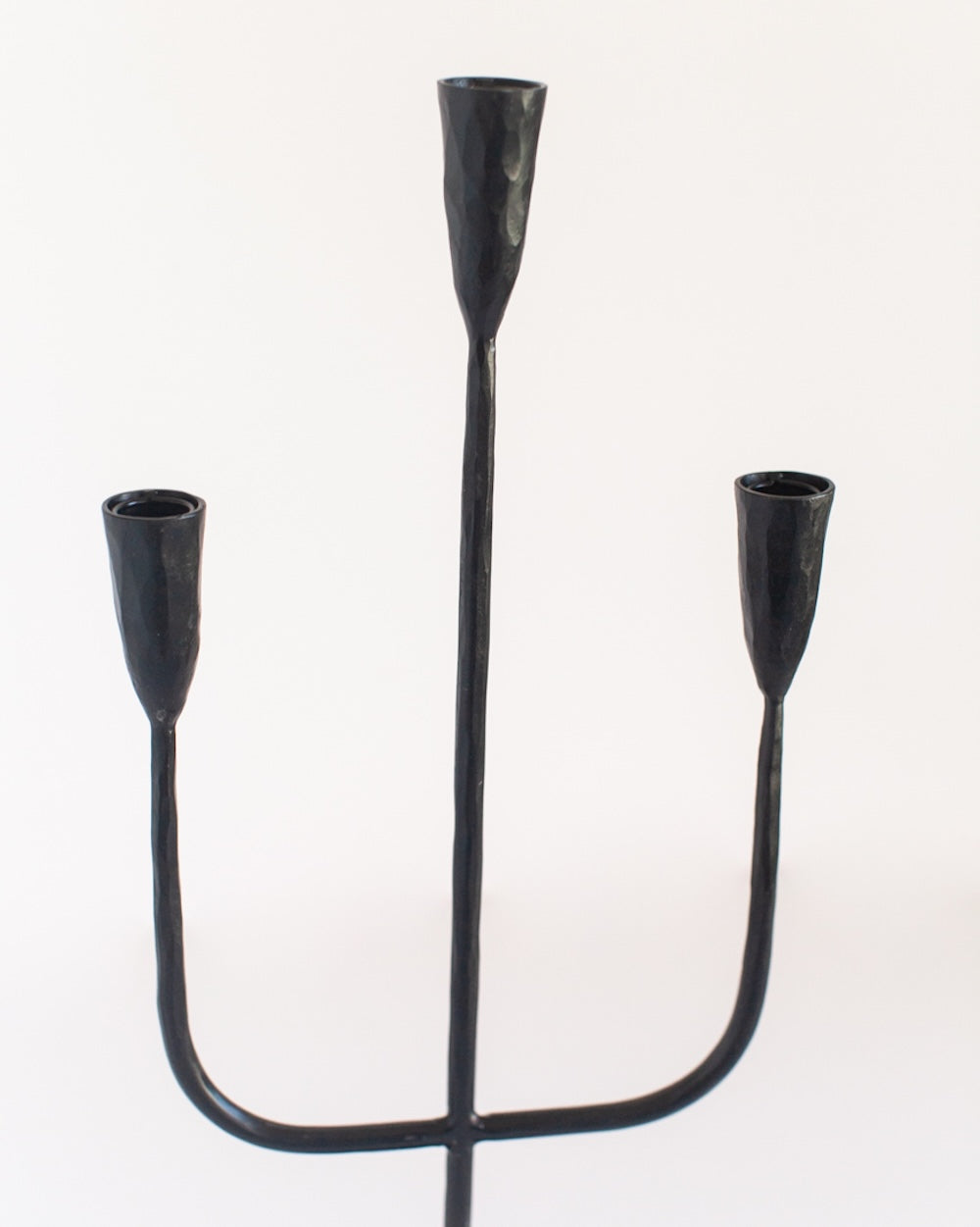 Black metal candelabra on a white background
