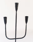 Black metal candelabra on a white background