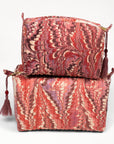 Two red patterned bags stacked on a white background