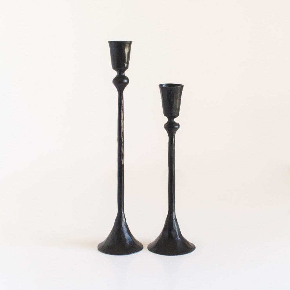 Two black candle holders on a white background