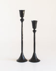 Two black candle holders on a white background