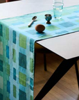 Blue table runner with a geometric pattern on a table