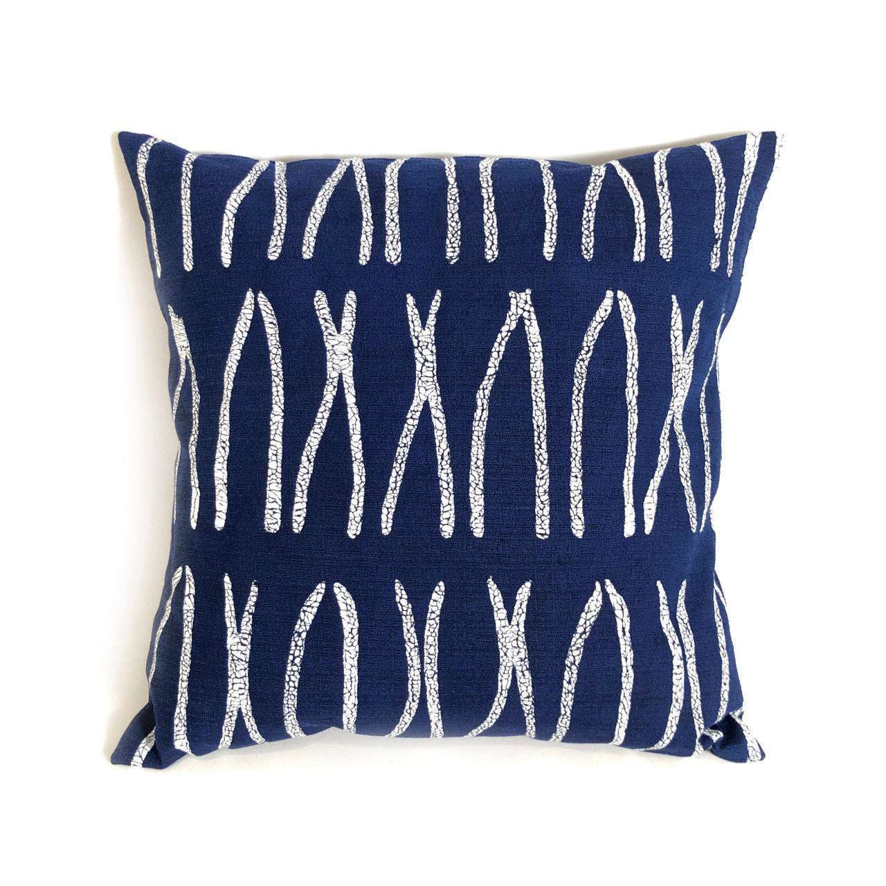 Navy blue pillow with white abstract pattern on a white background