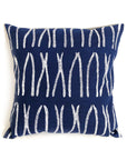Navy blue pillow with white abstract pattern on a white background