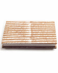 Notebook with a beige and white striped cover on a white background