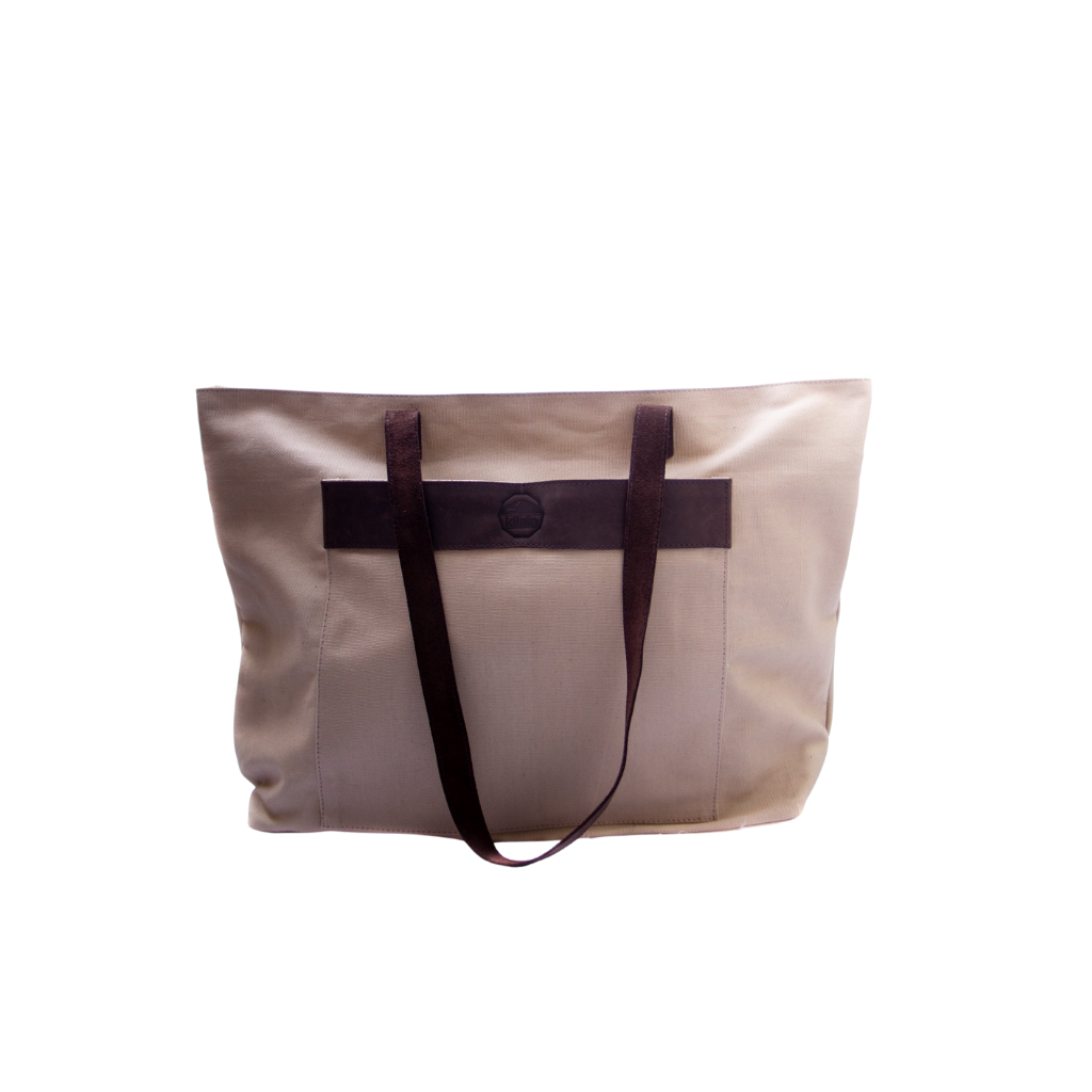 A beige canvas tote bag with brown leather accents and dark brown straps, standing upright against a solid background.
