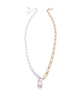 A necklace with a silver plated paperclip chain, a gold plated paperclip chain, and a silver toggle clasp with a freshwater pearl hanging from it.