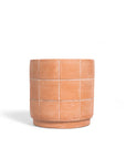 Terracotta-colored planter with grid pattern on a white background