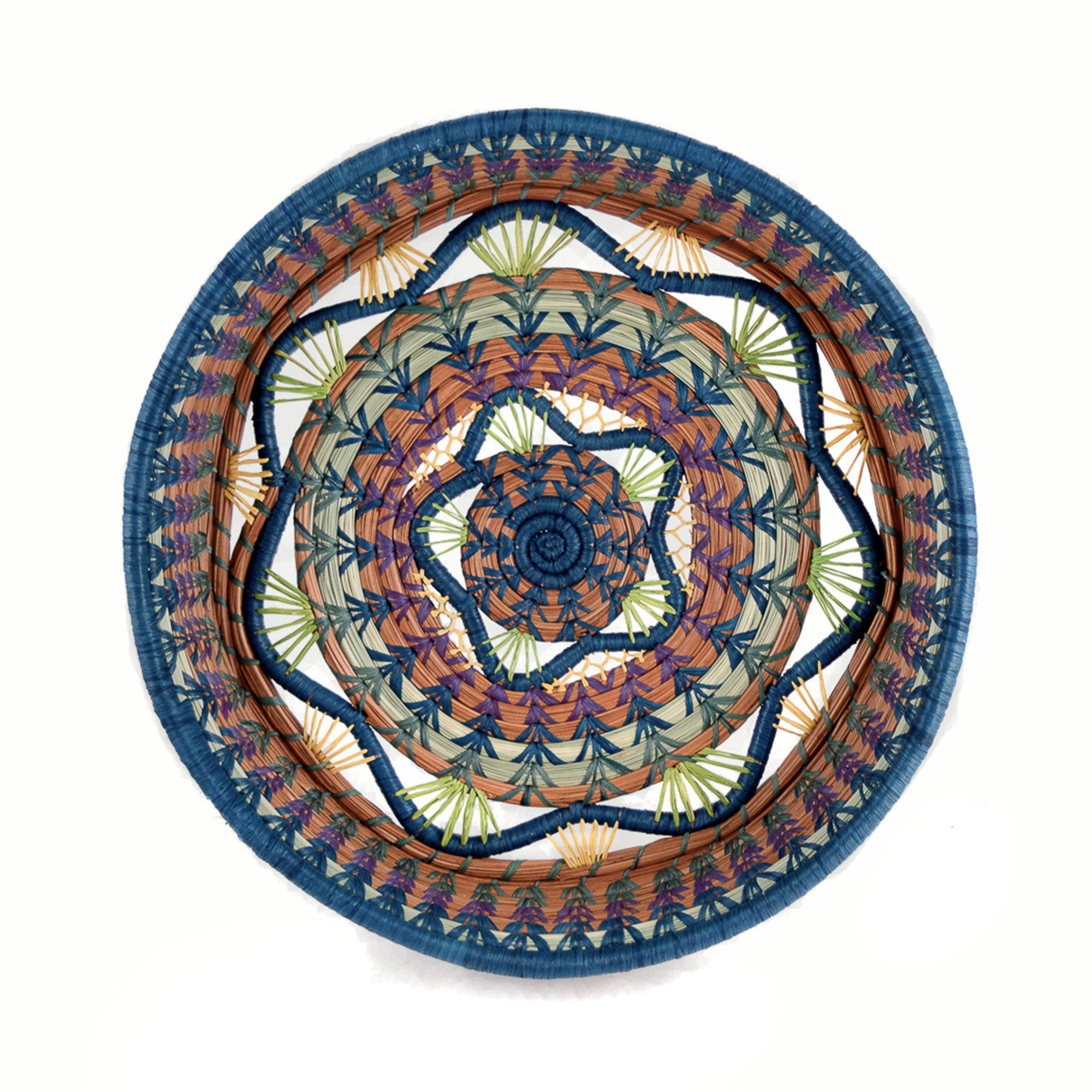 Decorative woven basket with concentric circular pattern on a white background