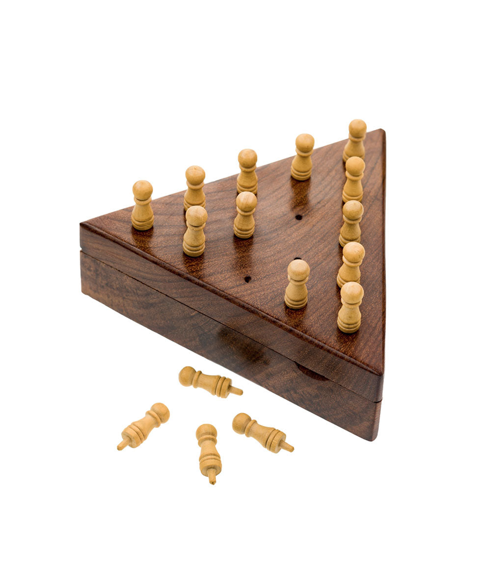 Triangle solitaire peg board game with the pegs inside the hole and four pegs outside the holes.