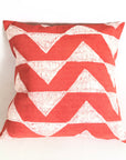 Red and white chevron patterned pillow on a white background