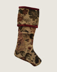 A reversible Christmas stocking featuring a floral tapestry design on one side and a solid red color with a floral pattern on the other, displayed against a white background