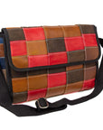 A crossbody bag with a patchwork design made from upcycled leather, featuring a black nylon strap and interior pockets, in brown, red, and blue colors.
