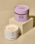 Osmology Dream Catcher candle and packaging on a beige background