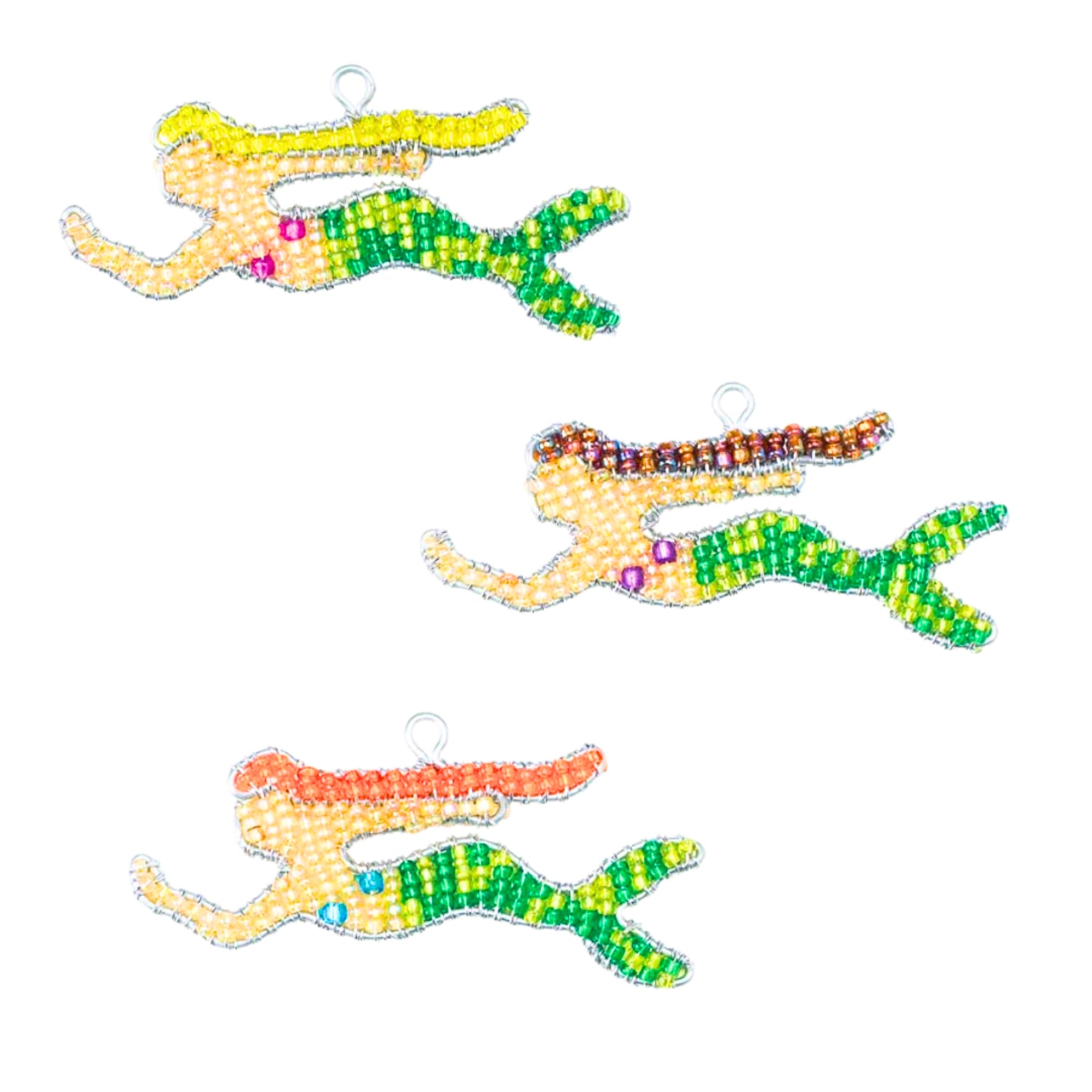 Three colorful beaded mermaid keychains on a white background