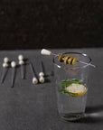 Clear glass with garnishes on a dark surface