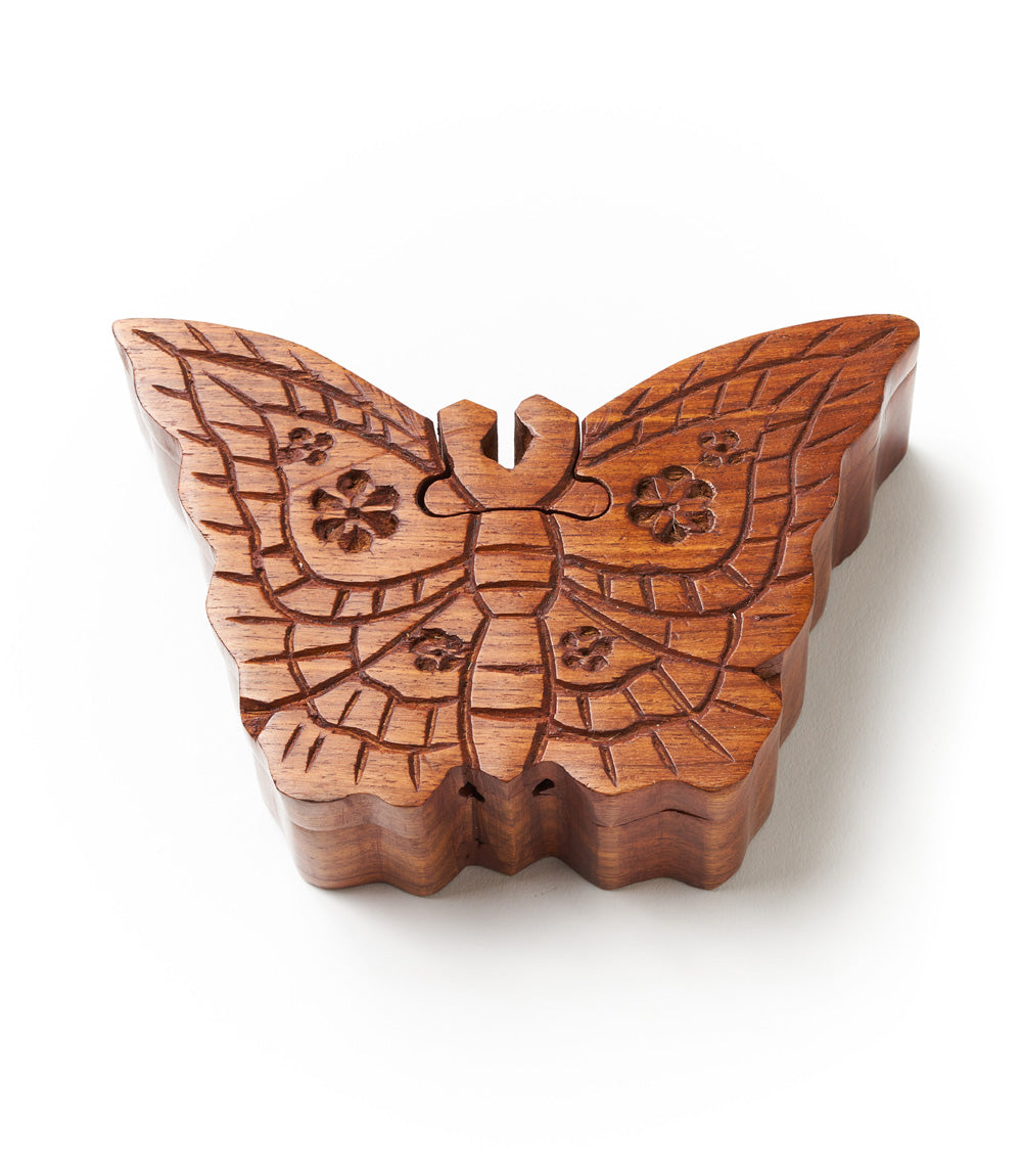 A handcrafted wooden butterfly puzzle box made from solid Indian rosewood with intricate details resembling lace patterns.