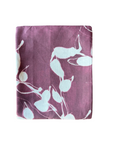 Folded tablecloth with light blue floral pattern on a purple background