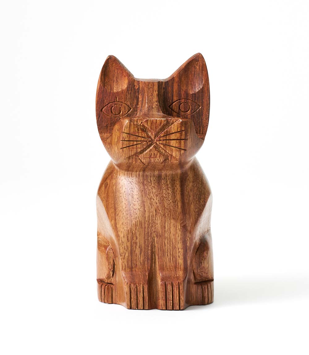 A hand-carved wooden eyeglass holder stand in the shape of a cat with a brown finish.