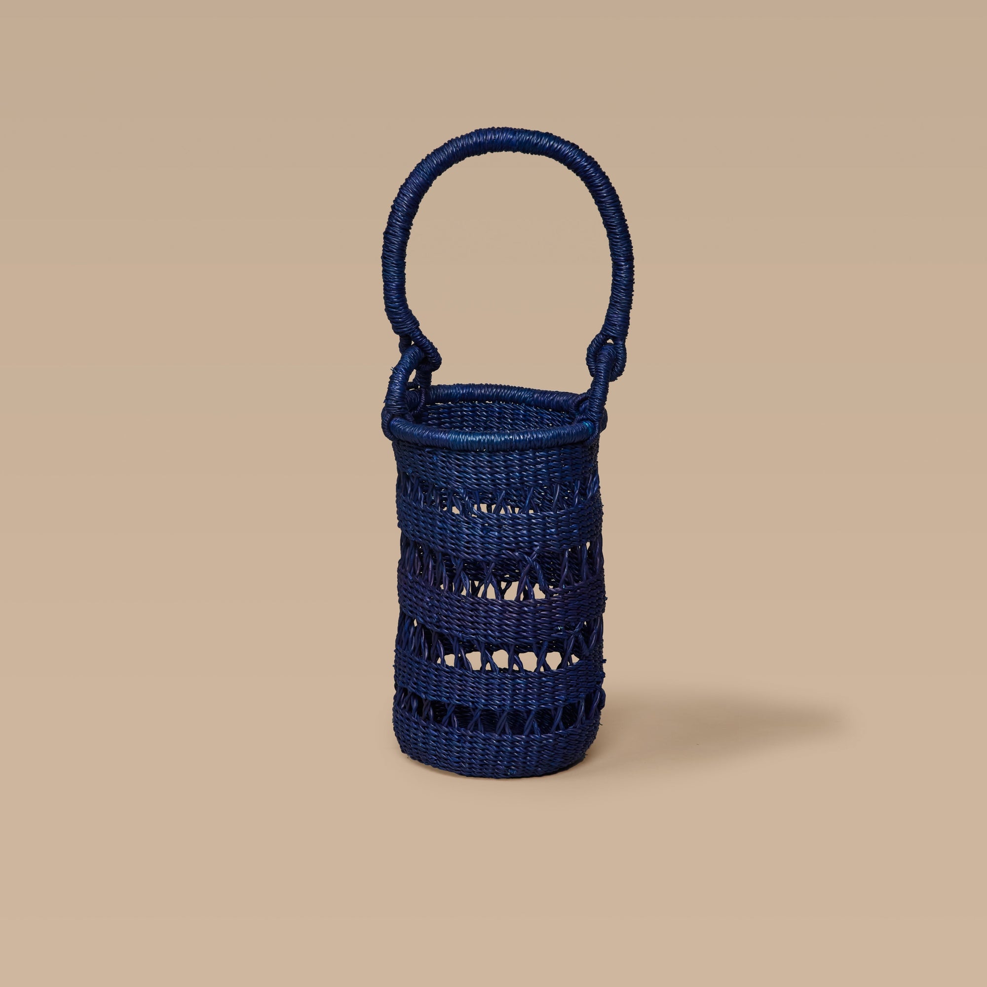 A blue wine tote made from elephant grass, featuring an open weave design and a handle for carrying.