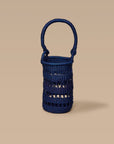 A blue wine tote made from elephant grass, featuring an open weave design and a handle for carrying.